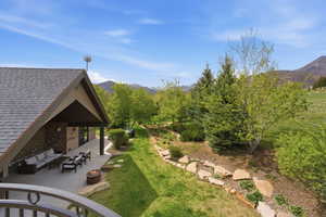 View of grassy yard with a patio, a mountain view, and outdoor lounge area