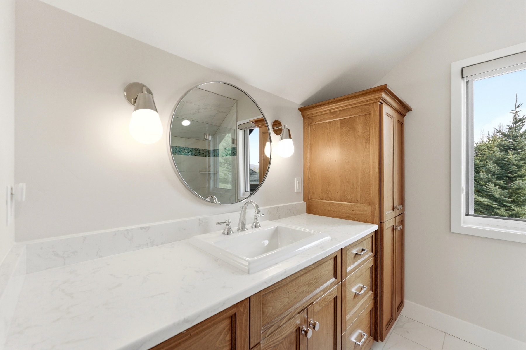 Full bathroom with vanity, a shower stall, and lofted ceiling