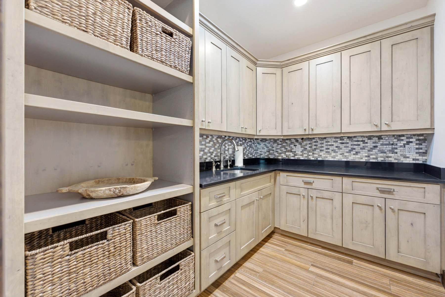 Laundry area featuring light wood-type flooring and a sink