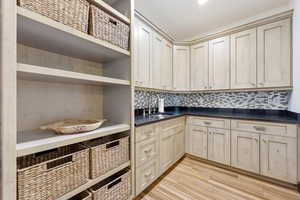 Laundry area featuring light wood-type flooring and a sink