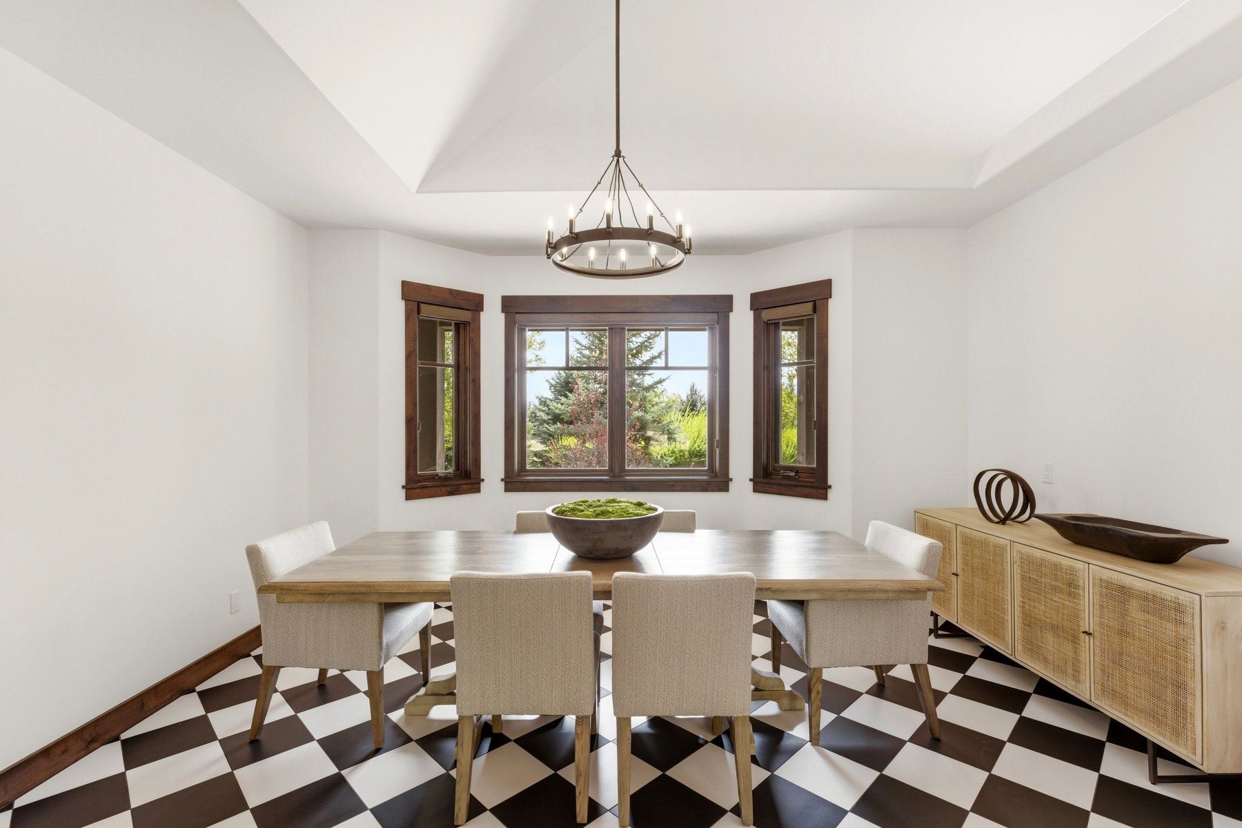 Dining room with dark floors, a chandelier, a raised ceiling, and lofted ceiling