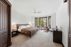 Bedroom featuring light colored carpet and a ceiling fan