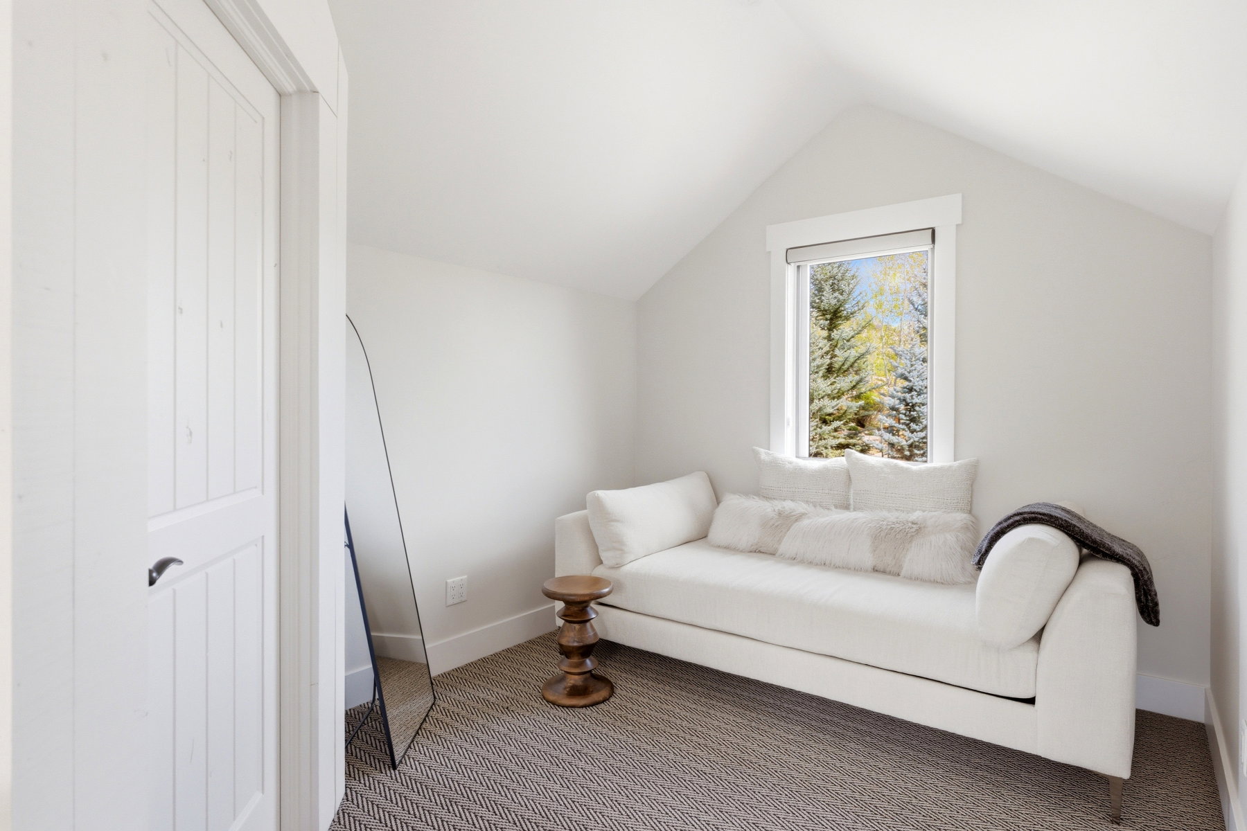 Living area featuring carpet and baseboards