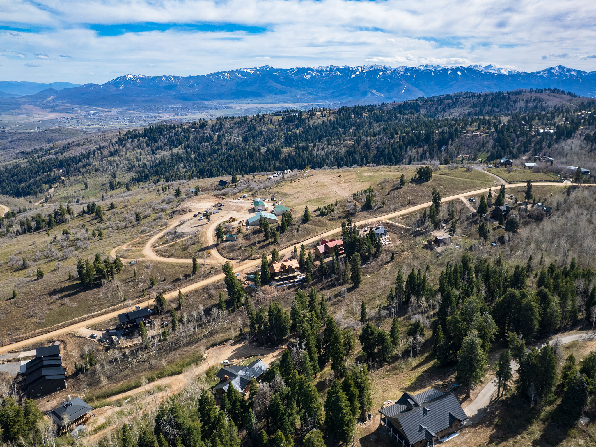 Drone / aerial view of mountains and a heavily wooded area
