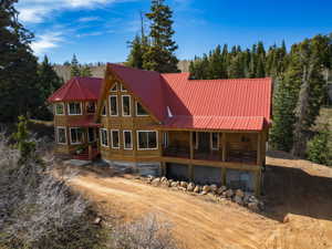 Back of property featuring a metal roof