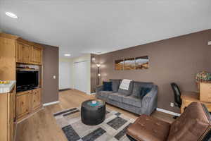 Living room with baseboards and light wood-type flooring