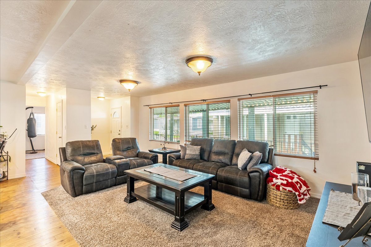 Living room featuring a textured ceiling and wood finished floors
