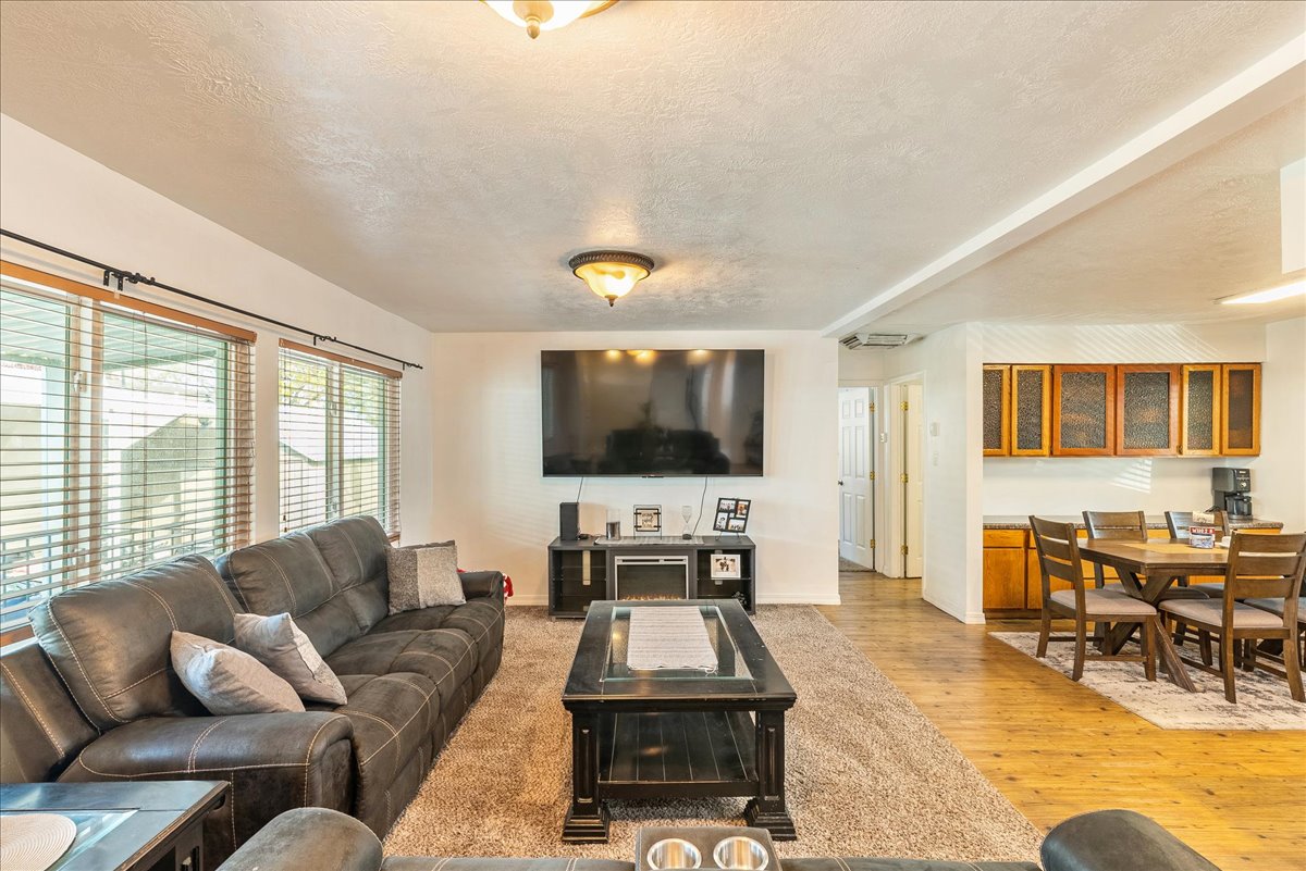 Living room featuring a textured ceiling and light wood-style floors