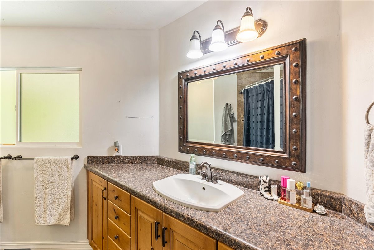 Bathroom featuring vanity and curtained shower