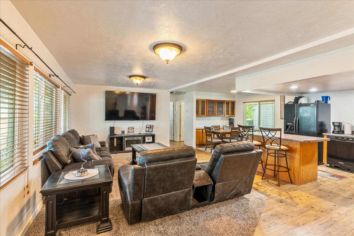 Living room featuring a textured ceiling and light wood-type flooring