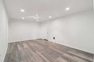 Empty room featuring recessed lighting and dark wood finished floors