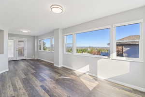 Unfurnished sunroom with french doors and a mountain view