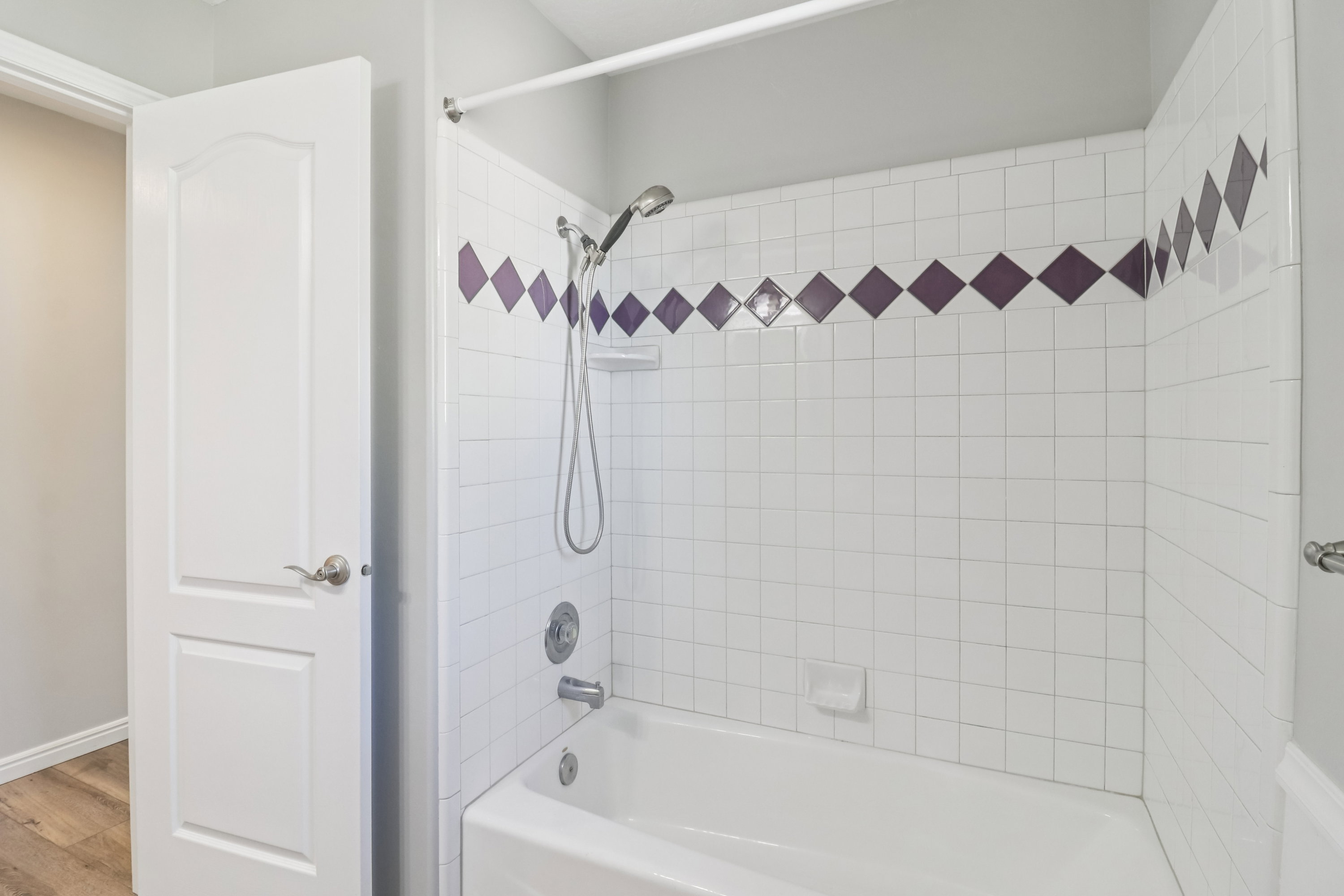 Full bathroom with shower / bathtub combination and light wood finished floors