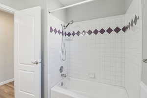 Full bathroom with shower / bathtub combination and light wood finished floors