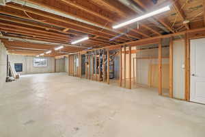 Unfinished basement featuring water heater