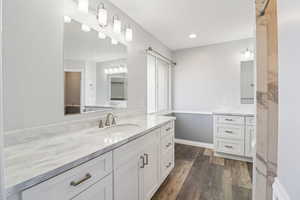 Full bath featuring wainscoting, vanity, dark wood finished floors, and recessed lighting
