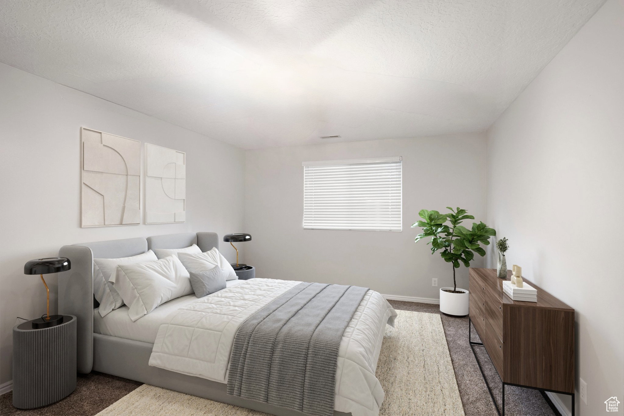 Bedroom featuring carpet flooring and a textured ceiling
