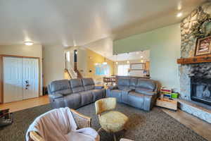 Living area featuring a fireplace and vaulted ceiling