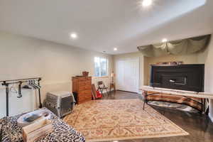 Sitting room with recessed lighting and finished concrete flooring