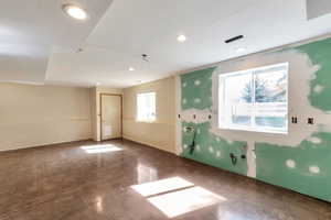 Spare room with finished concrete flooring and recessed lighting