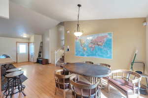 Dining area featuring lofted ceiling and light wood finished floors