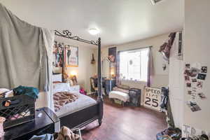 Bedroom featuring dark wood-style flooring