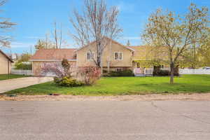 Tri-level home with concrete driveway and an attached garage