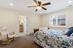 Bedroom with recessed lighting, a ceiling fan, dark colored carpet, and connected bathroom