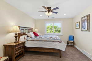 Bedroom featuring dark carpet, a ceiling fan, and recessed lighting