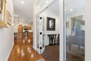 Corridor featuring vaulted ceiling, recessed lighting, and dark wood finished floors