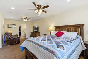 Bedroom with recessed lighting, ceiling fan, connected bathroom, and dark carpet