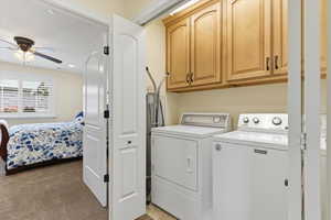 Laundry area with cabinet space, ceiling fan, light colored carpet, washing machine and clothes dryer, and recessed lighting