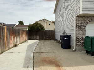 View of side of property with RV parking, a fenced backyard, and brick siding