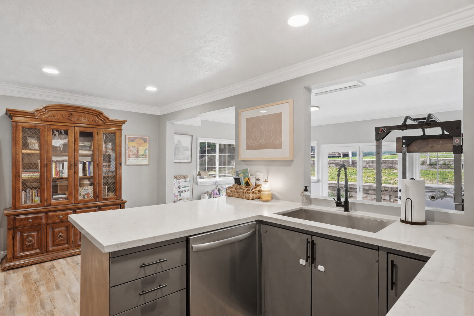 Kitchen featuring light-toned perimeter walls, recessed lighting, and crown molding