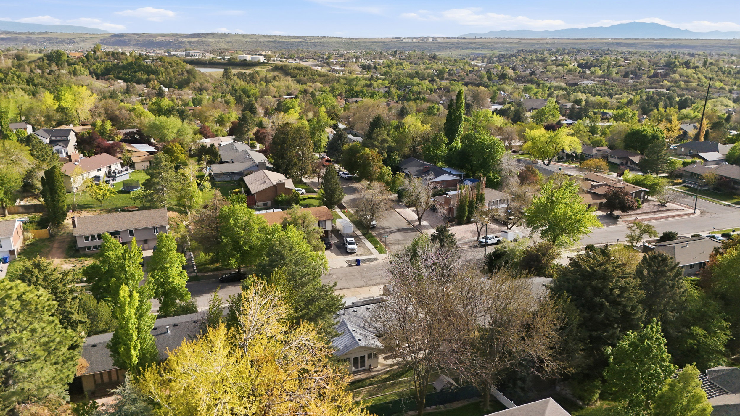 Aerial perspective of suburban area with a mountain backdrop