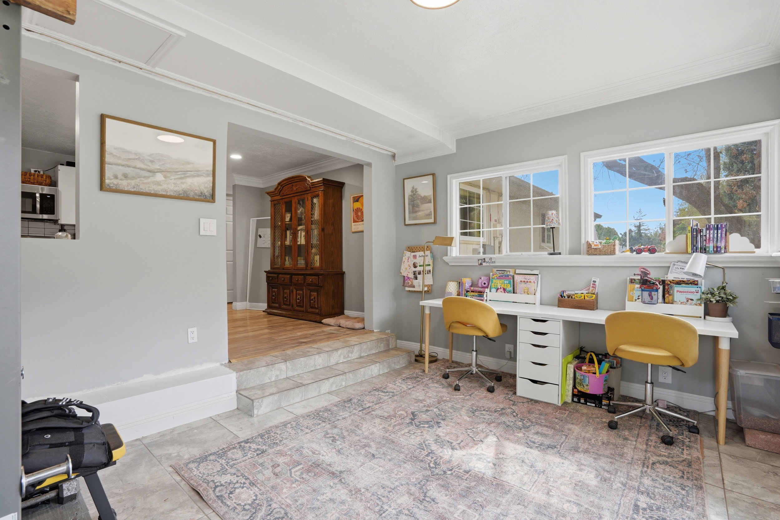 Home office with ornamental molding and light tile patterned floors