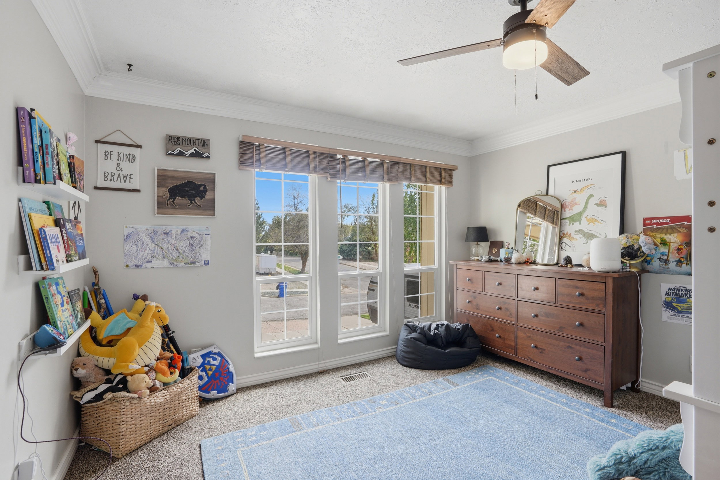 Sitting room with ornamental molding, light colored carpet, and ceiling fan