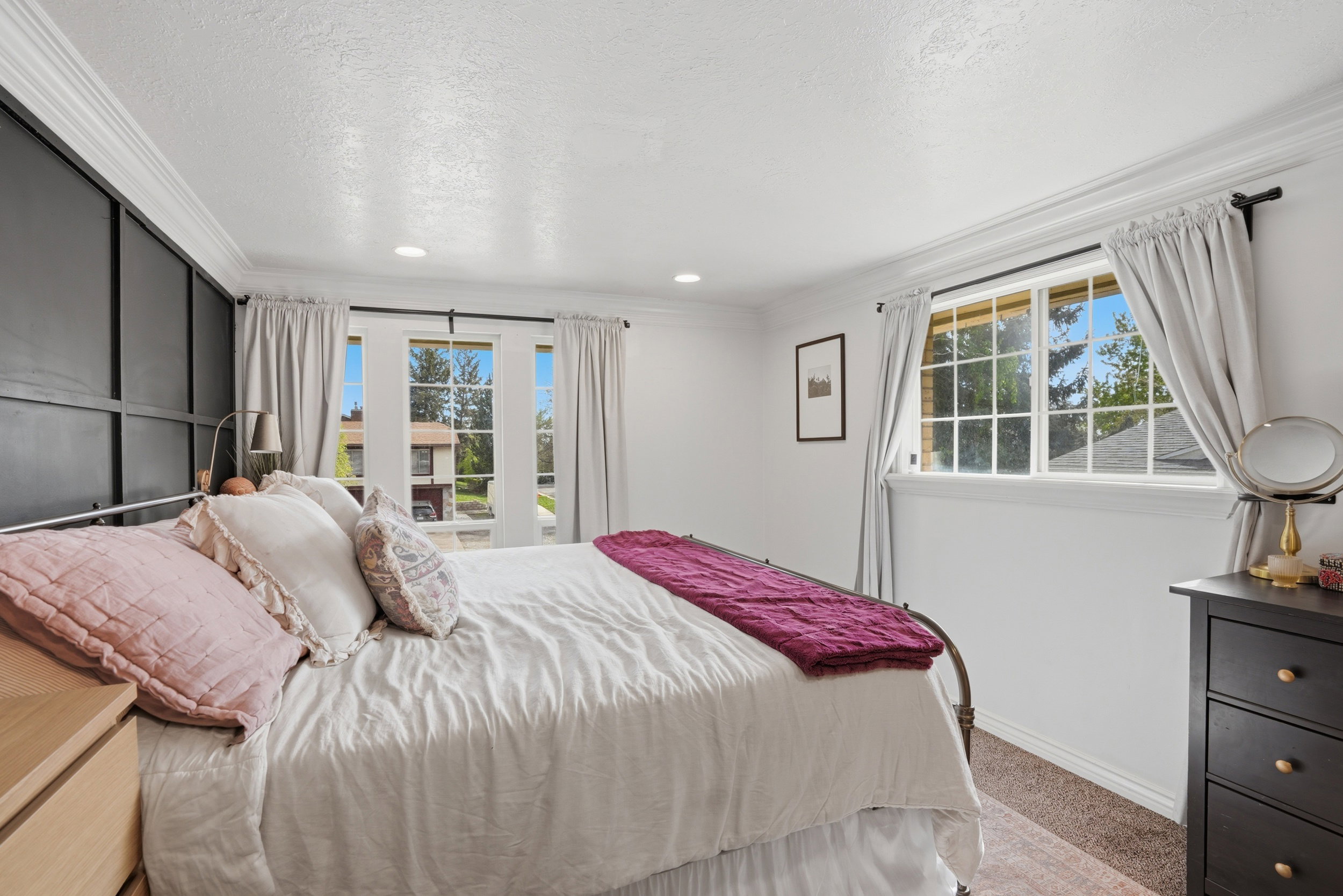 Bedroom with light colored carpet, ornamental molding, recessed lighting, and a textured ceiling