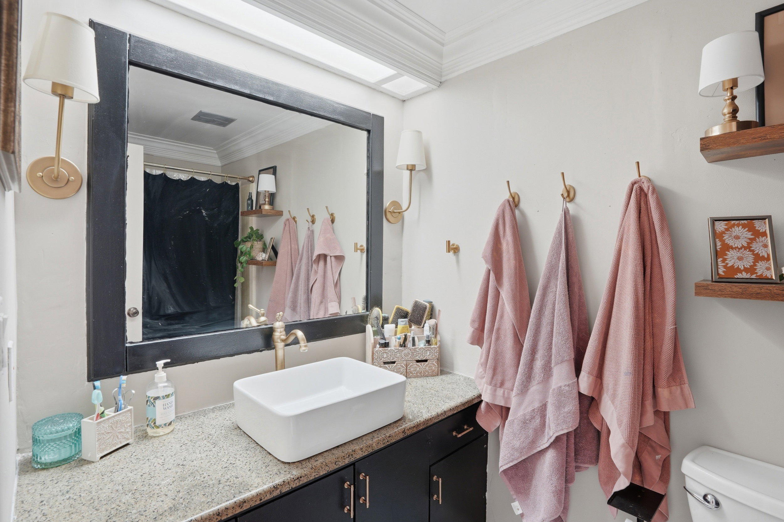 Bathroom with crown molding, vanity, and curtained shower