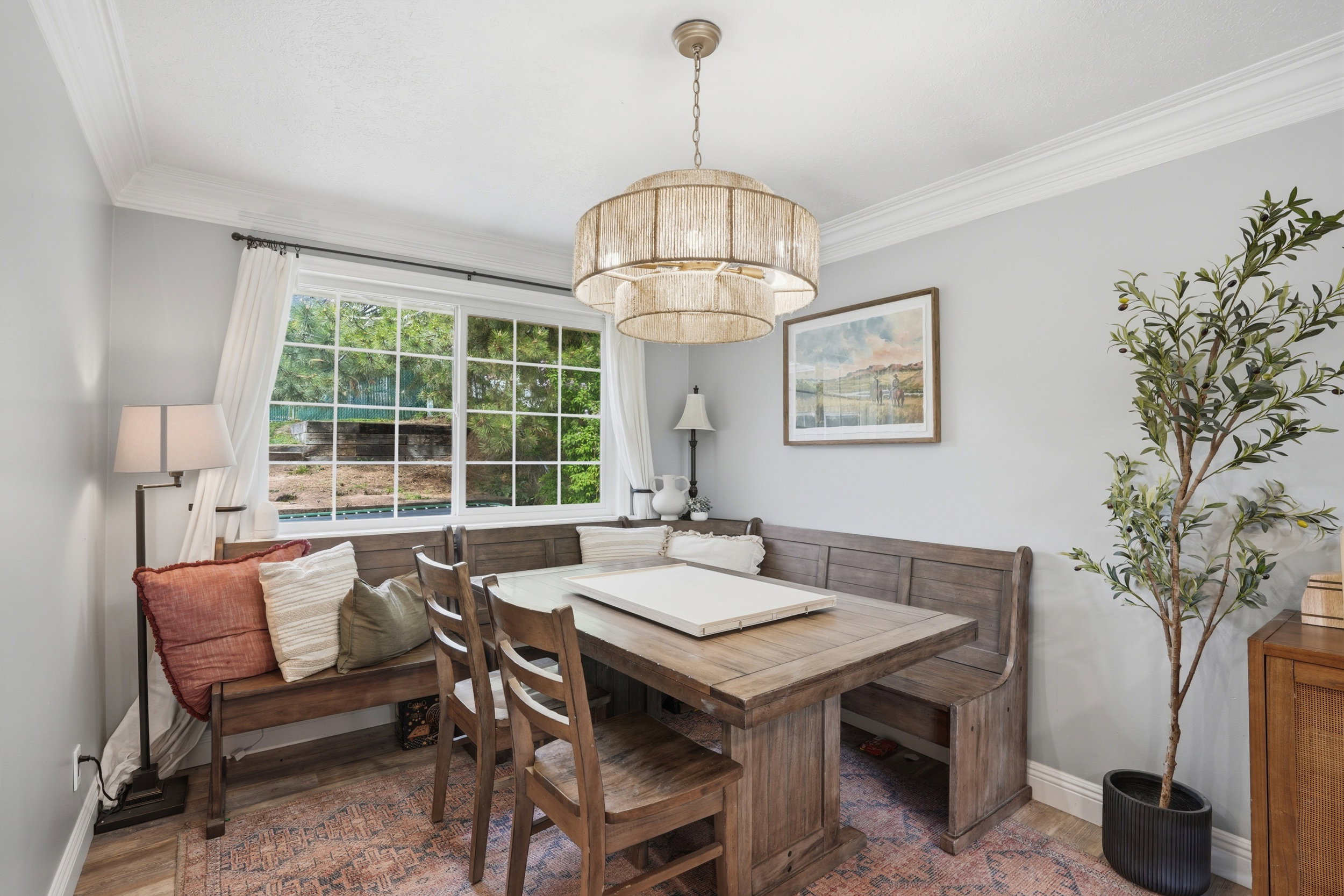 Dining area with crown molding and wood finished floors