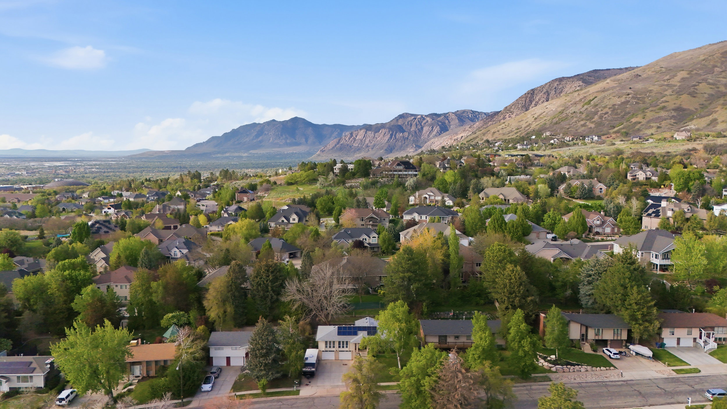 Aerial perspective of suburban area with a mountainous background