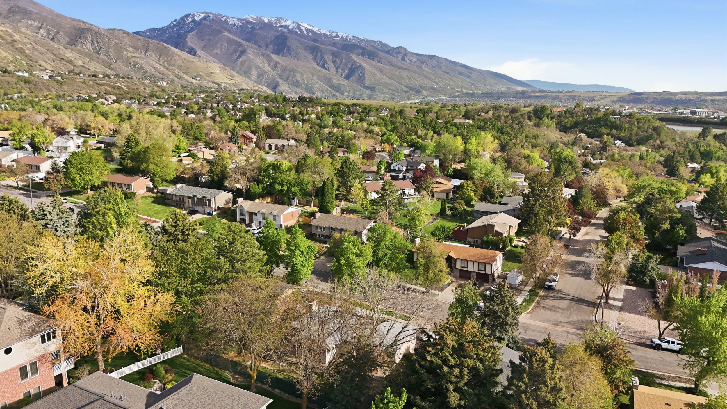 Aerial perspective of suburban area with a mountain backdrop