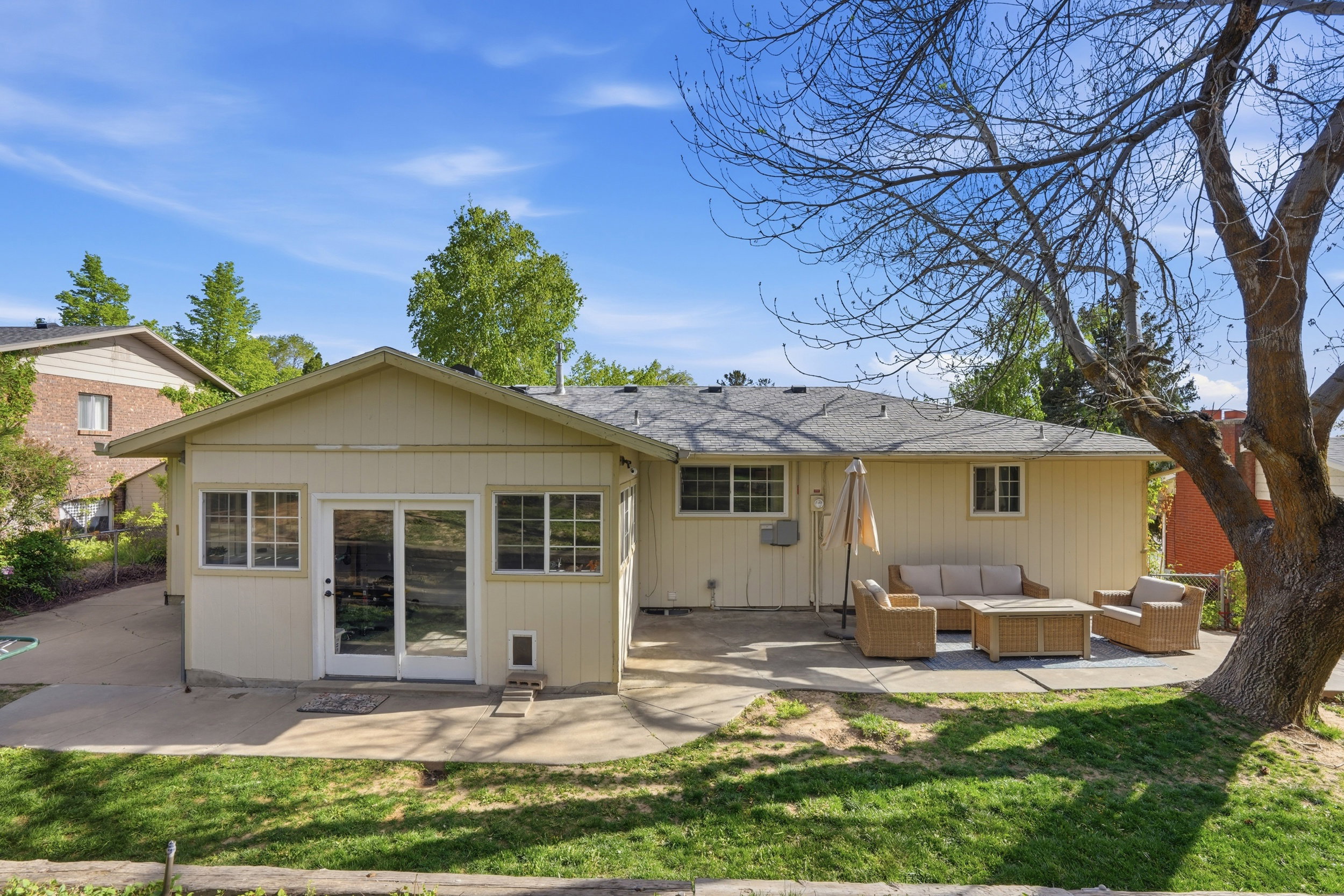 Back of house with a patio, a yard, roof with shingles, and an outdoor living space