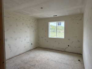 Empty room featuring a textured ceiling