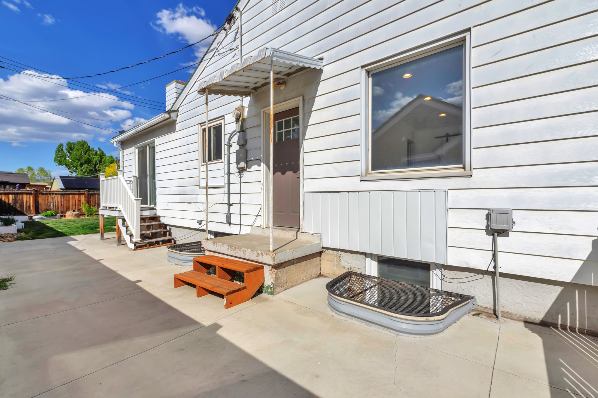 Doorway to property featuring a patio and a chimney