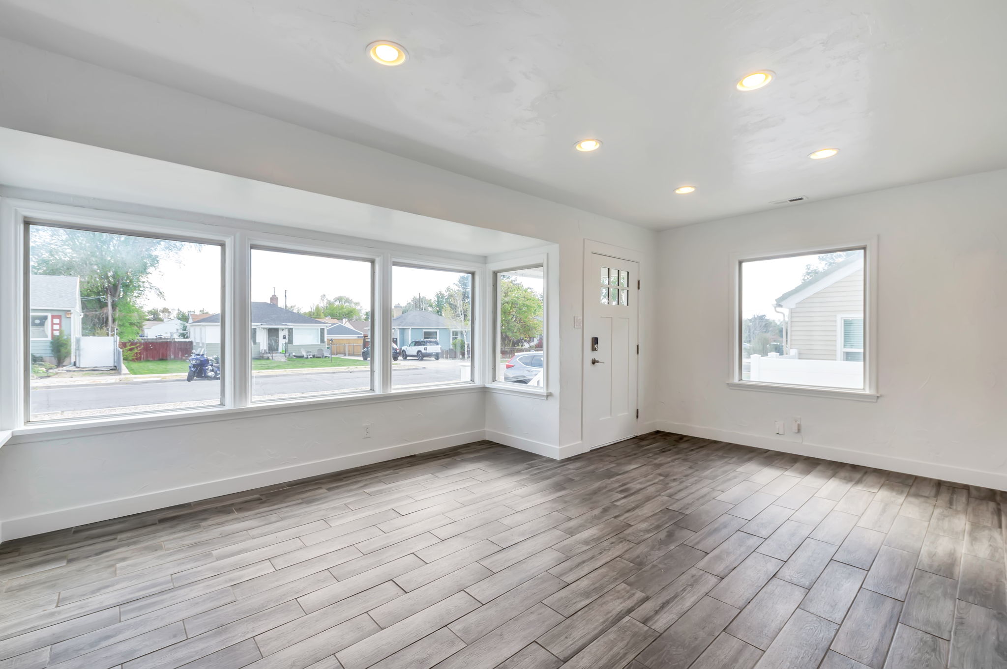 Entrance foyer with wood finish floors, recessed lighting, and a residential view