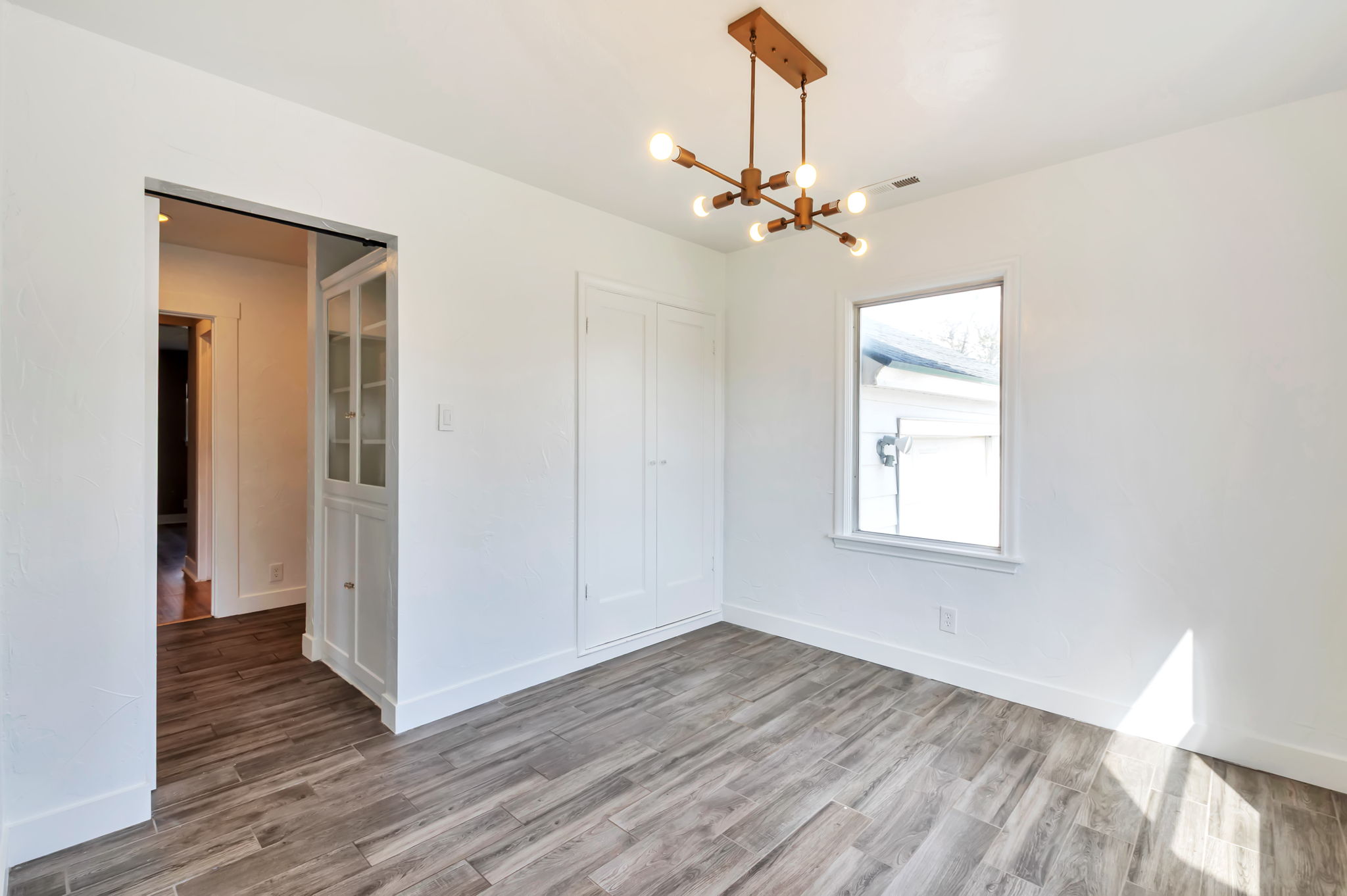 Unfurnished dining area with a chandelier and wood finished floors
