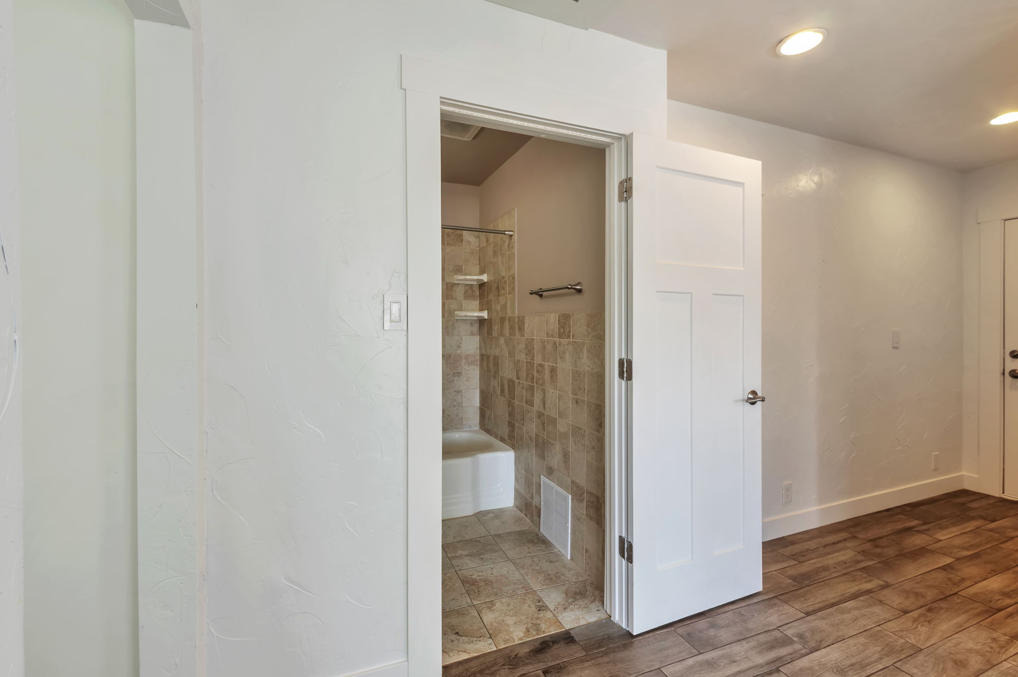 Bathroom with wood finished floors and baseboards