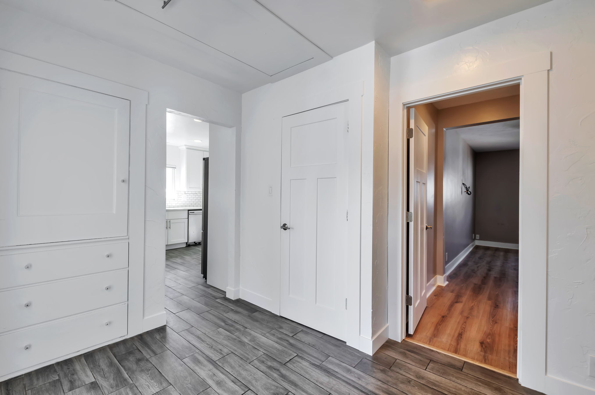 Hall featuring dark wood-style floors and baseboards