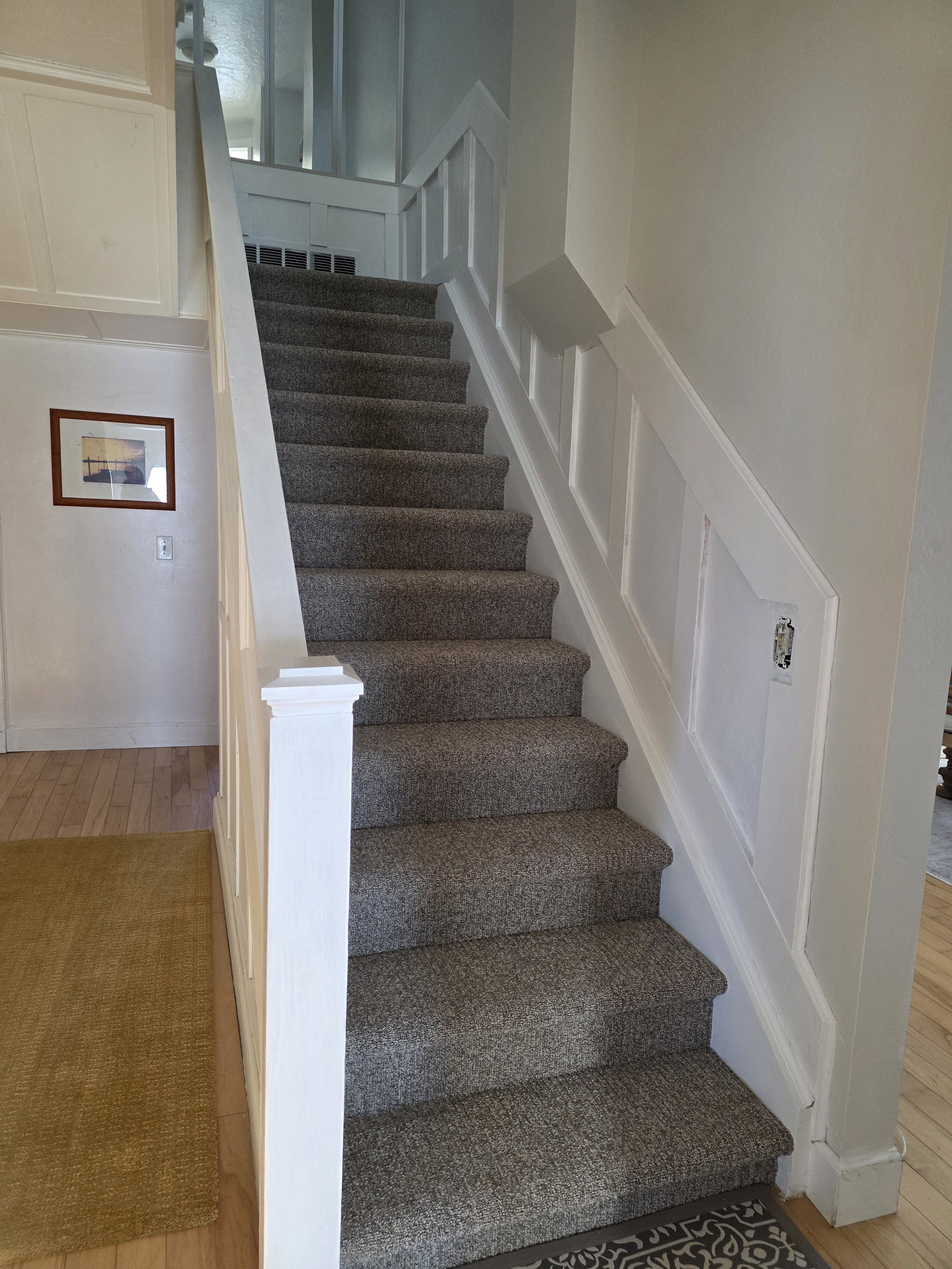 Stairs featuring hardwood / wood-style floors